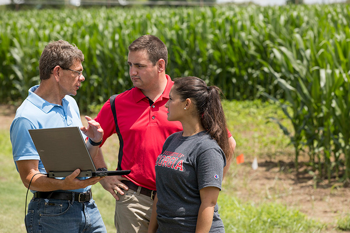 George Vellidis, a professor in the department of crop and soil sciences and University Professor, reviews surface water runoff data with students at the UGA Tifton campus.