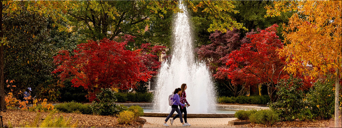 Students walking by fountain on Herty Field at the University of Georgia