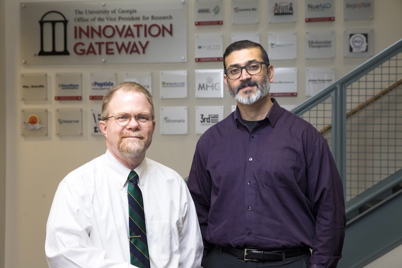 (L-R) Donnie Longenecker, College of Environment and Design, and Lohitash Karumbaiah, Animal and Dairy Science pose in the Innovation Gateway lobby.