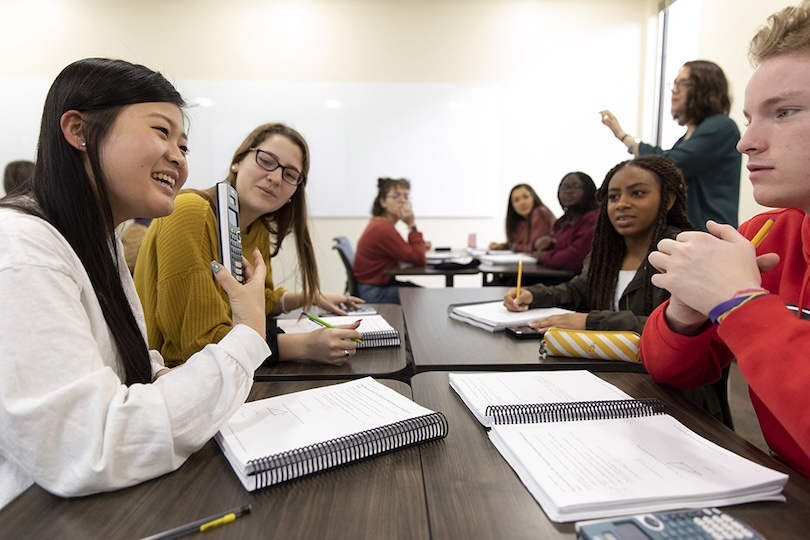 (L-R) Undergraduate students Danny Wang, Sarah-Jane Hanig, Aniyah Norman, and Cameron Williams work together in a group in their Calculus I class inside a classroom in the Boyd Graduate Studies Research Center.