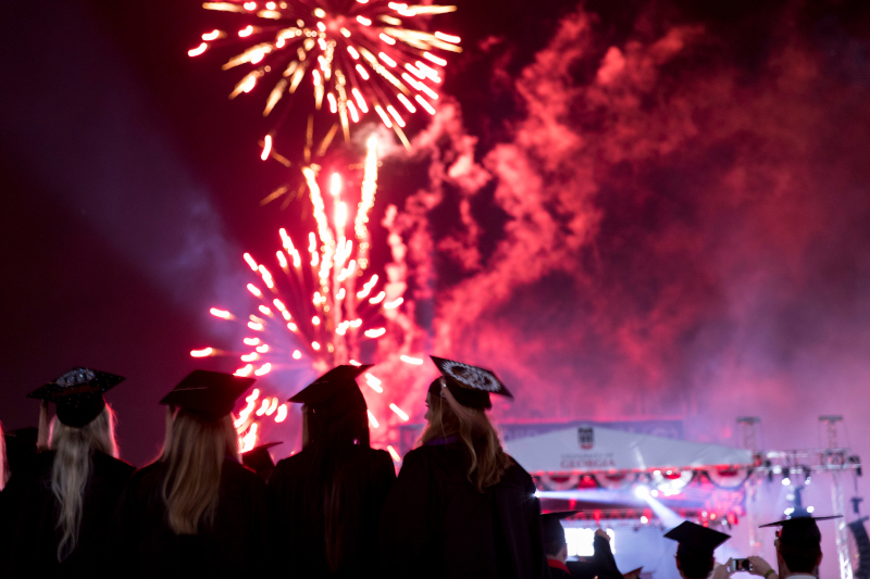 Undergraduate students watch the fireworks at the end of the 2018