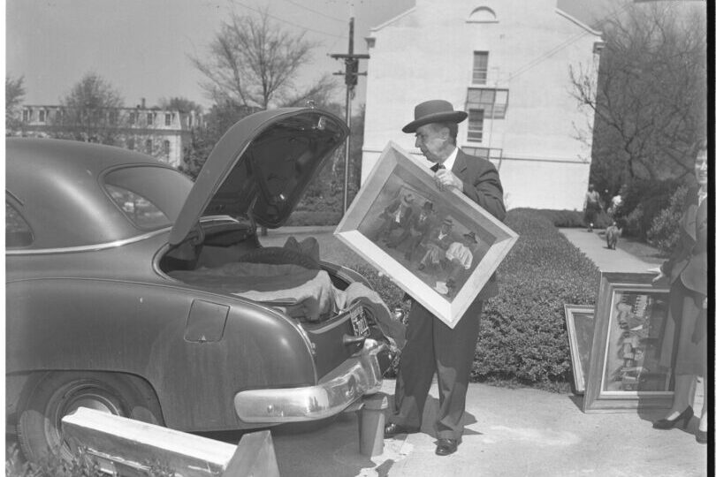 Alfred Heber Holbrook putting a painting into the trunk of his car. (Submitted photo)