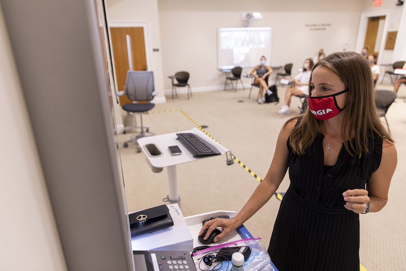 Synovus Director of the Institute for Leadership Advancement and Associate Professor Laura Little talks with her students on zoom as she teaches her class to students on zoom along with in-person students in Benson Hall on the first day of class of the fall semester.