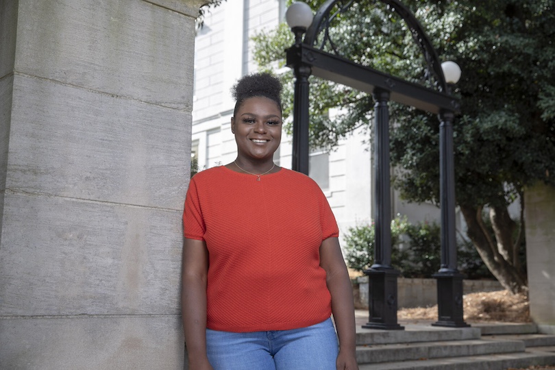 Portrait of undergraduate Jordan Delaney standing by the Arch.