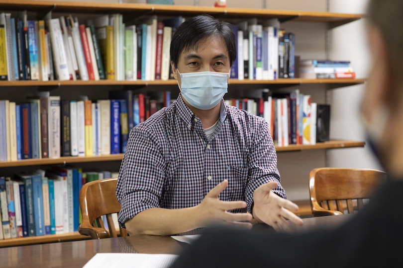 (L-R) Sociology professors Man Kit (Karlo) Lei and Ron Simons talk about their work together in Lei's office at Baldwin Hall.