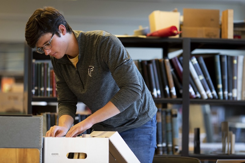 Student docent undergraduate Erik Quillian researches Elvis materials in the staff area at the Special Collections Libraries.