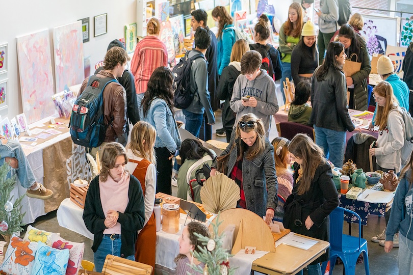 Visitors peruse artwork by 95 student artists for sale on Nov. 18 at the Lamar Dodd School of Art’s 2nd annual Dodd Market. Organized by the Dodd Ambassadors as part of Spotlight on the Arts, the market offers student artists a platform to practice pricing their work and marketing and engaging buyers. (Photo by Sidney Chansamone)