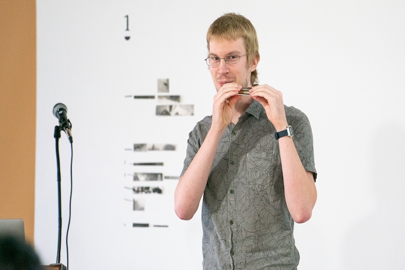 Daniel Karcher, DMA in music composition, was the grand prize winner at last year’s Four Minutes 33 Seconds Competition. His presentation about sonic spatialization in music composition included a live demonstration with a harmonica. (Photo by Sidney Chansamone)