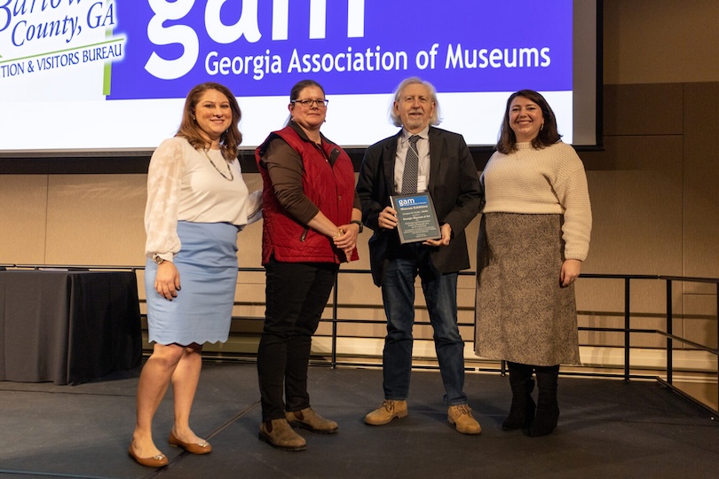 GAM award committee co-chairs Melissa Swindell and Karin Dalton, Georgia Museum of Art director William Eiland and GAM president Marcy Breffle with the award for Exhibition Category #3 ($25,001 – $99,999) for “Reckonings and Reconstructions: Southern Photography from the Do Good Fund.” (Submitted photo)