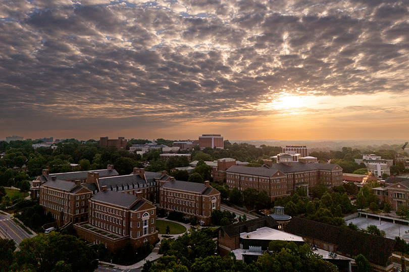 Aerial view of the sunrise over the Business Learning Community, Miller Learning Center and Tate Student Center.