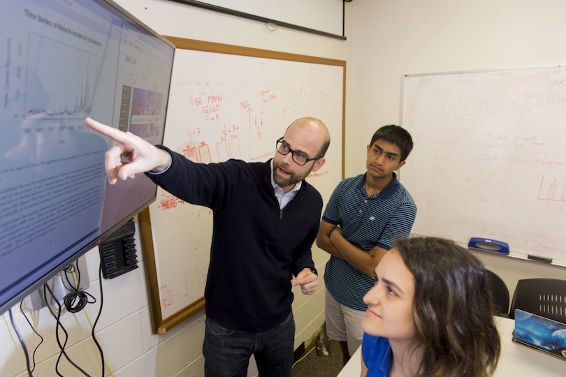 Ecology Professor John Drake, left to right, talks about his research with first year statistics major Aditya Krisnaswamy of Marietta and third year computational biology and math major Mallory Harris of Dunwoody and in his laboratory conference room.