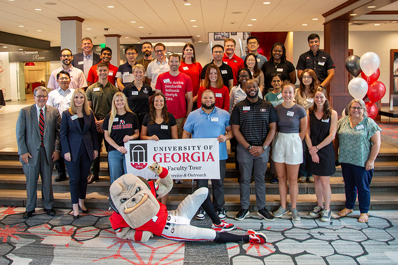 New Faculty Tour 2024 participants with President Jere W. Morehead and Jennifer Frum, vice president for public service and outreach, before the tour launches. (Photo by Mary Grace Feldman)