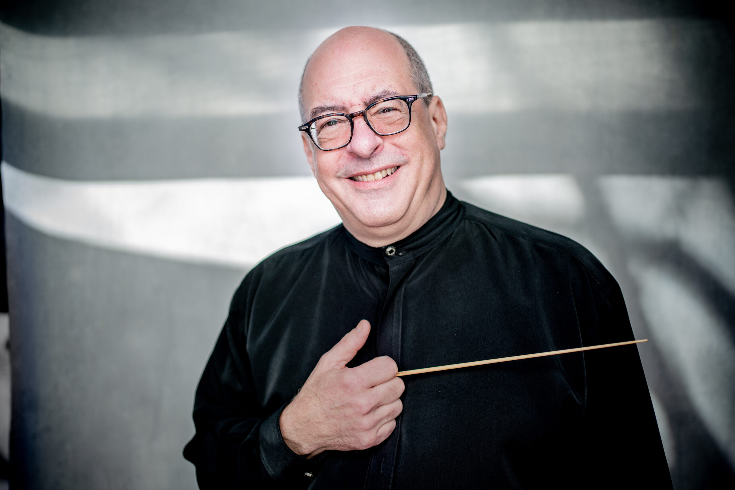 A portrait of Robert Spano holding a conductor's baton.