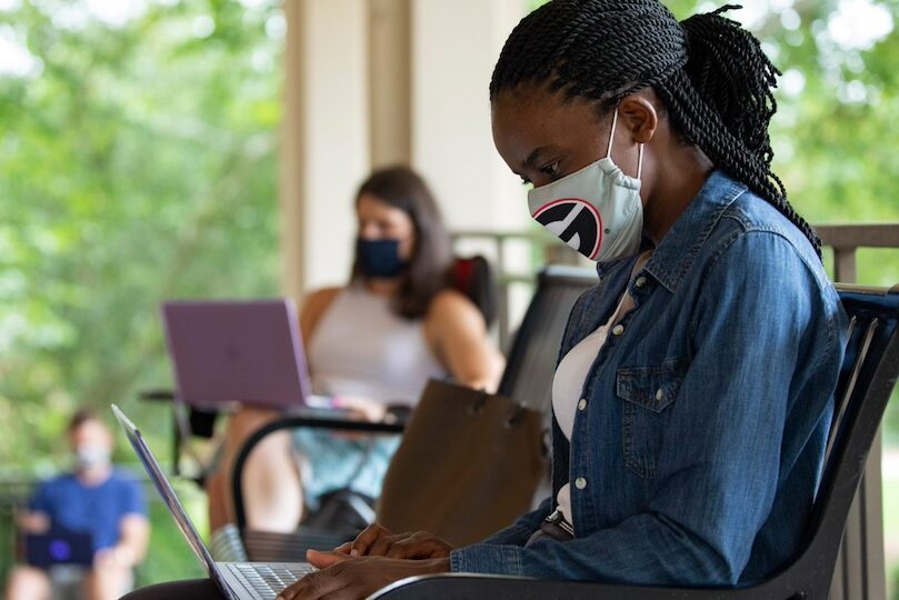 Graduate student Anne Waswa and her classmates participate in a doctoral class while social distancing outside Aderhold Hall.