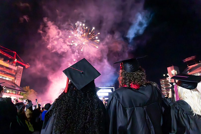 Graduating students celebrate during the fireworks display at the undergraduate Commencement ceremony in Sanford Stadium. (Dorothy Kozlowski/UGA)